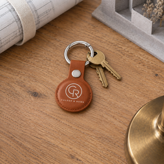 Brown leather AirTag holder with company logo on a set of keys