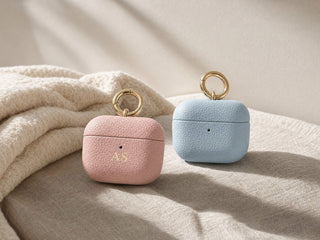 Pink and light blue personalised leather AirPods cases with gold ring clips