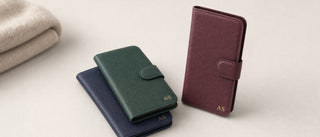 Personalised leather wallet phone cases in navy, green and burgundy with gold initials