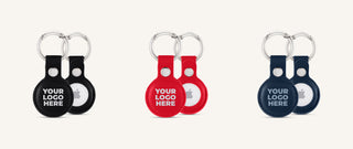 Three AirTag holders in black, red and blue with a printed logo