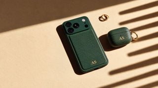 Matching green vegan leather iPhone and AirPods cases with gold initials